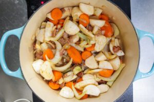 fennel, onions, and carrots sauteing in a pot