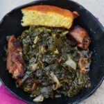 mess o greens in black bowl with cornbread