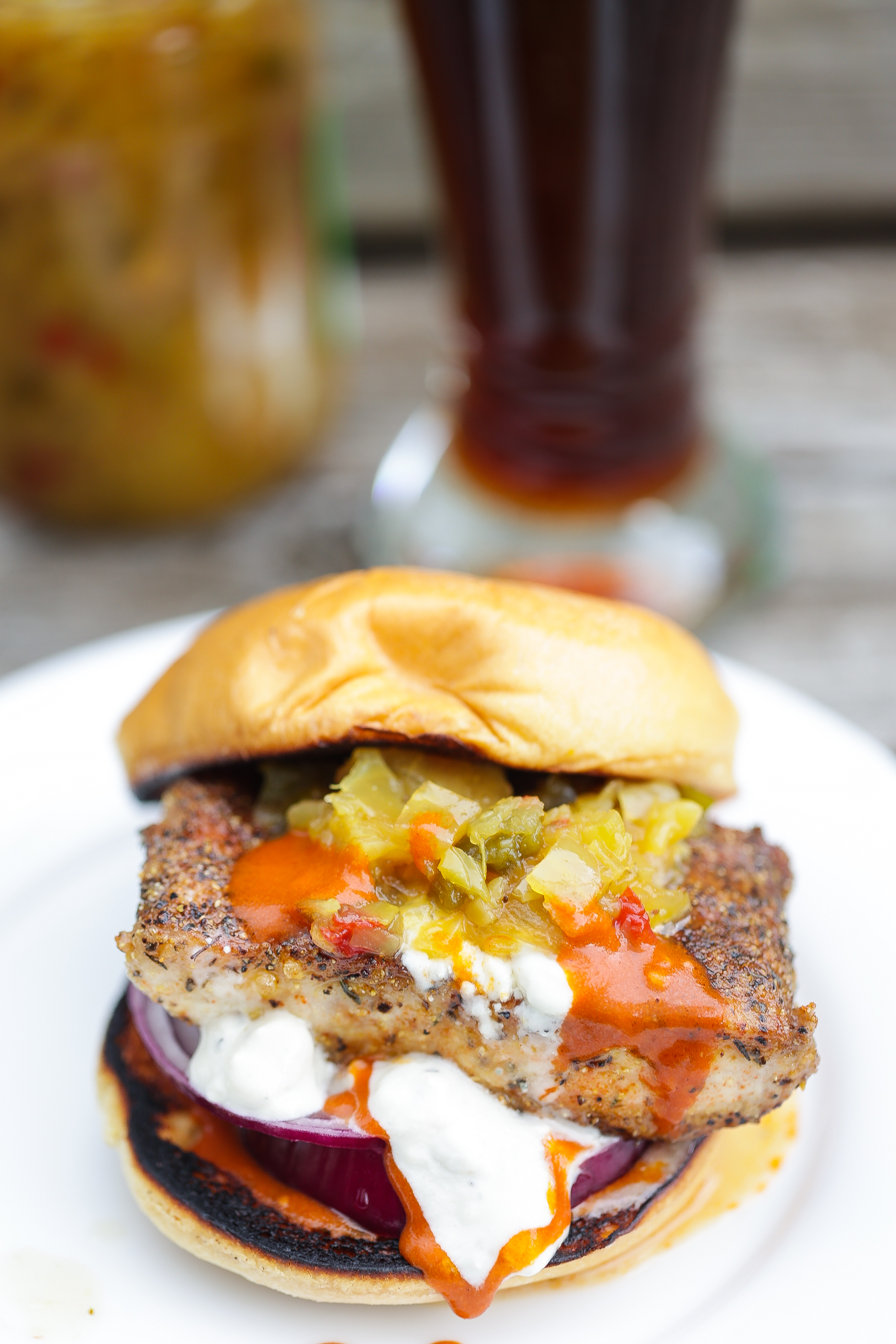 mahi mahi fish sandwich with orange and white sauces