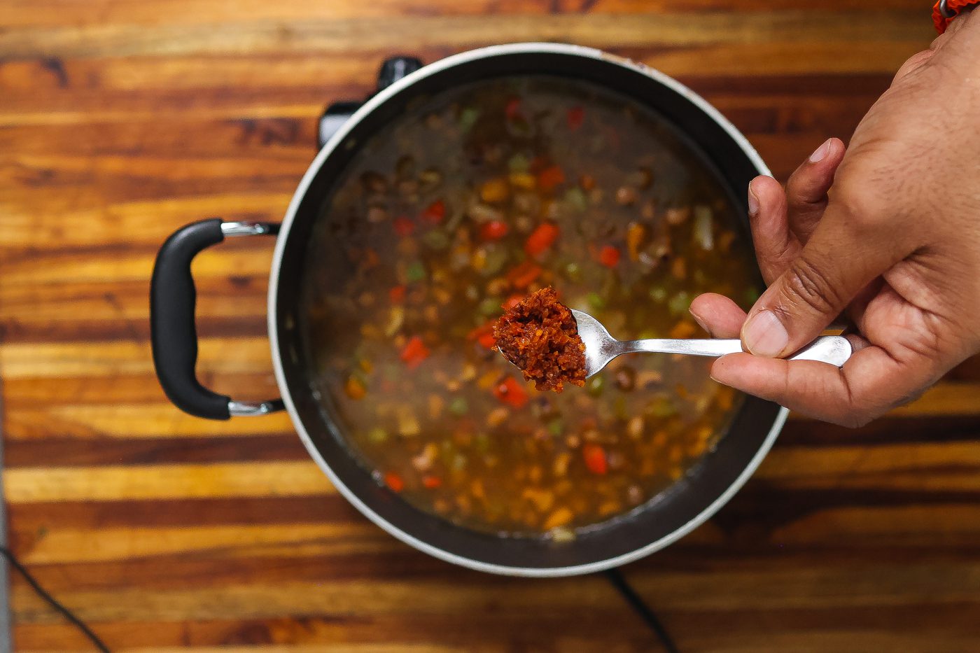 shrimp paste being added to catfish stew