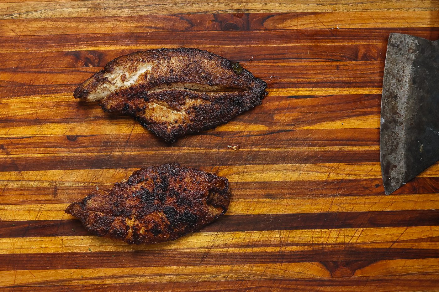 blackened catfish filets on a cutting board