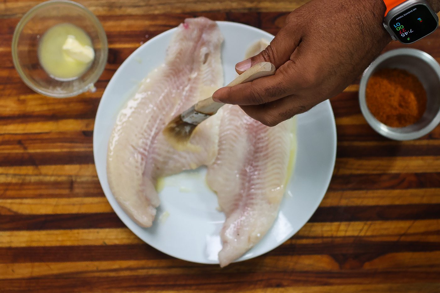 brushing catfish fillets with butter