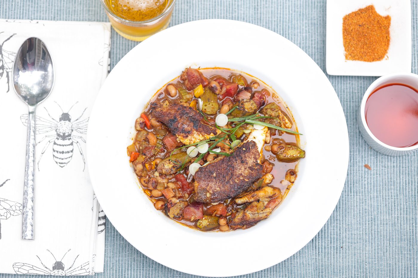 blackened catfish stew with okra and peas in a bowl