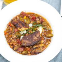 blackened catfish stew with okra and peas in a bowl