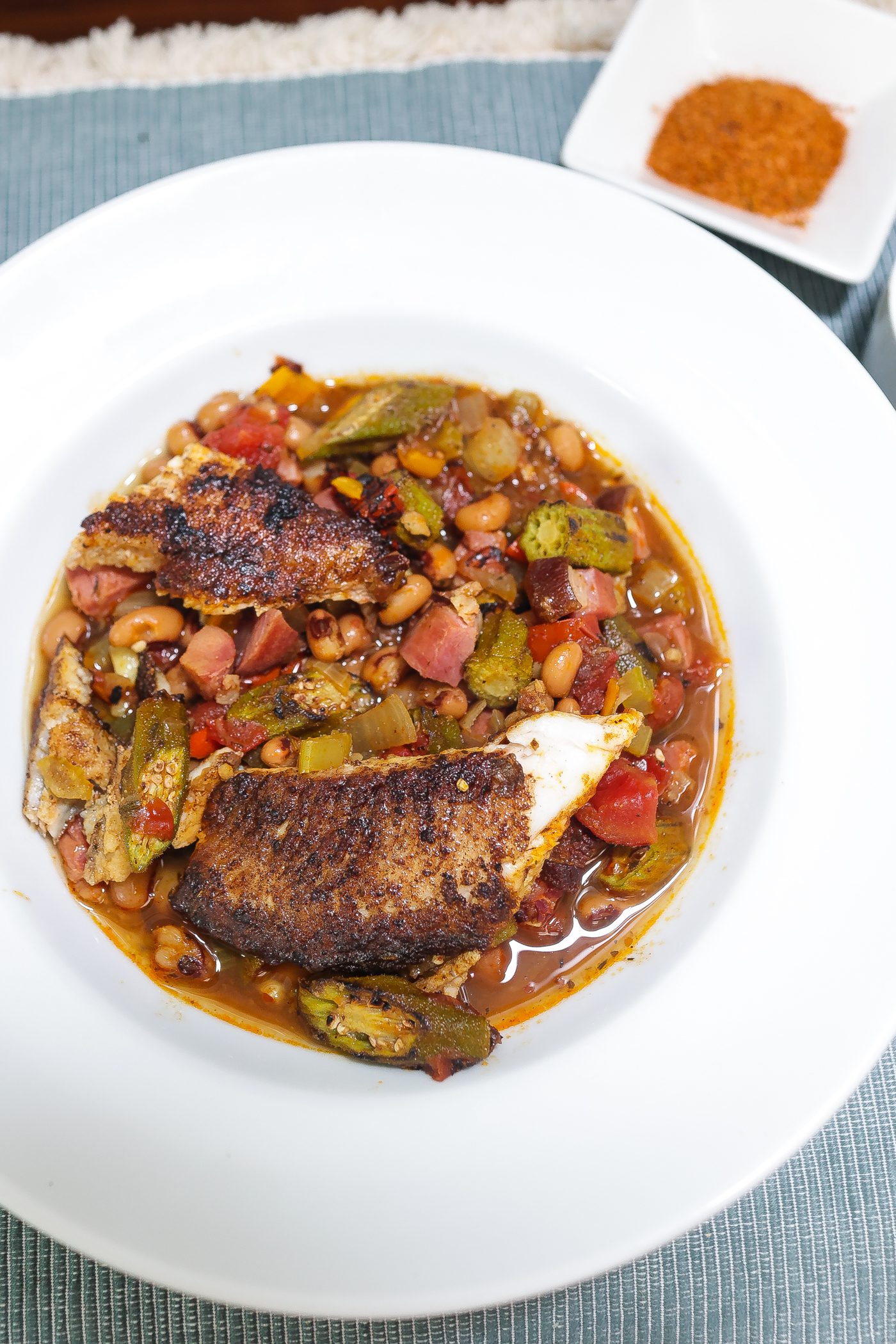 blackened catfish stew with okra and peas in a bowl