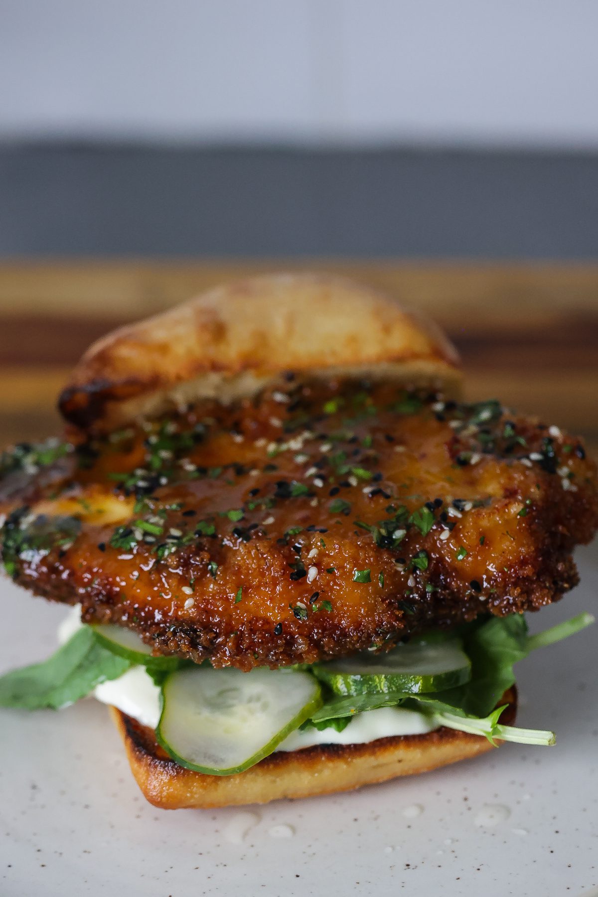 orange chicken sandwich on white plate