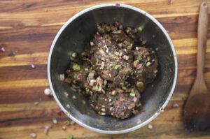 jamaican oxtail with butter beans and jollof rice in white bowl