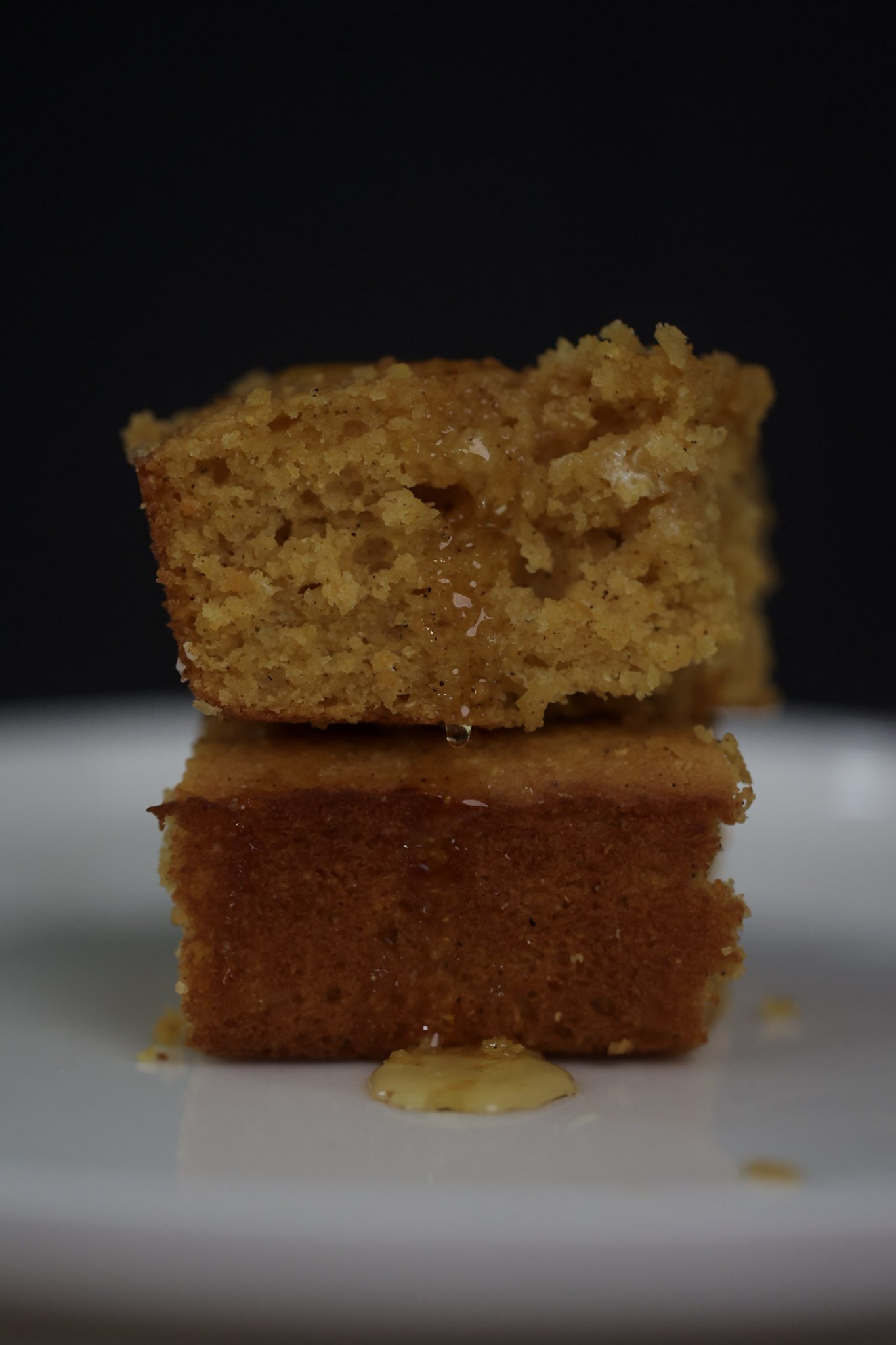 two sweet potato cornbread squares stacked on a plate