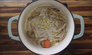 onions and pepper sauteing in pan