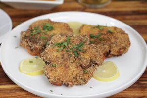 3 salmon croquette patties on a white plate