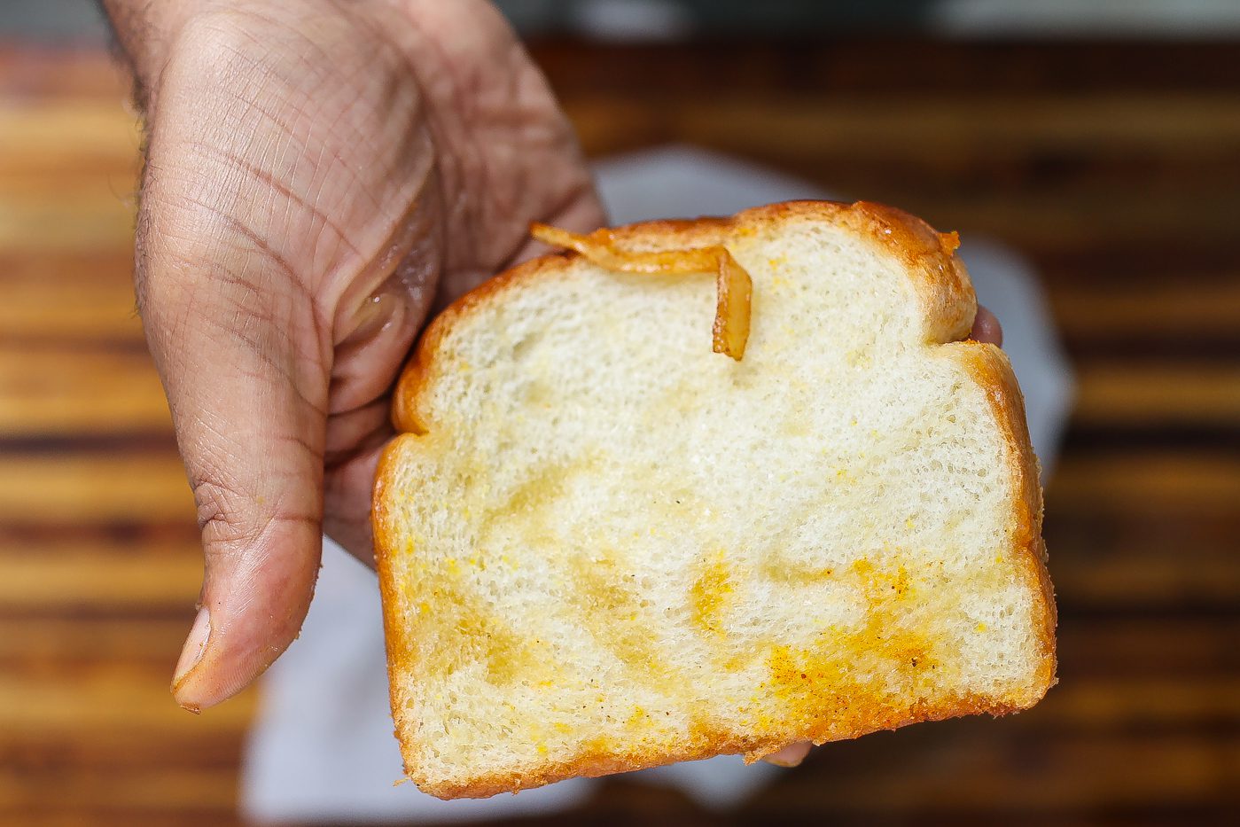 grease soaked bread in hand