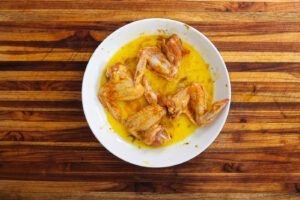 seasoned chicken wings covered in egg wash