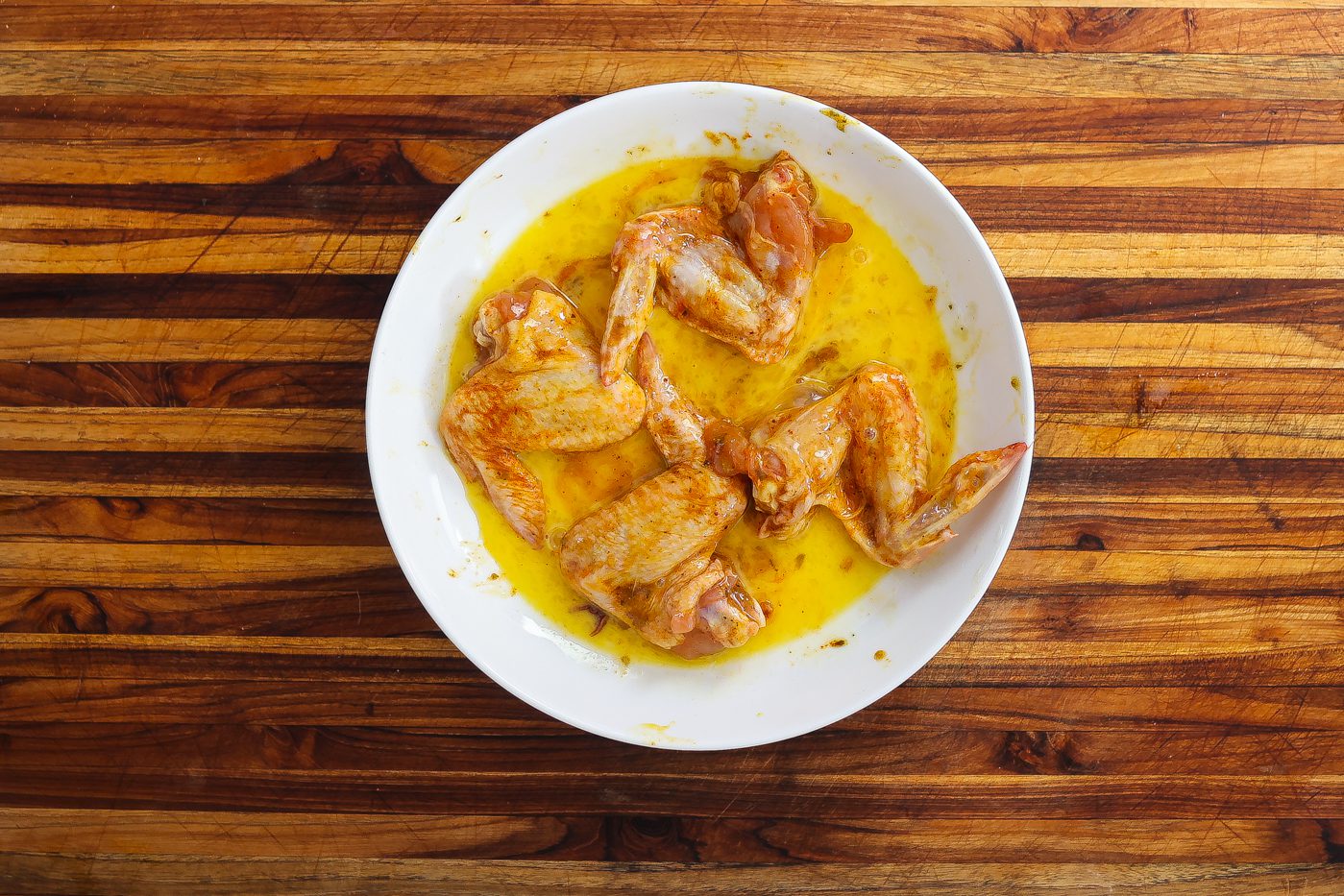 seasoned chicken wings covered in egg wash