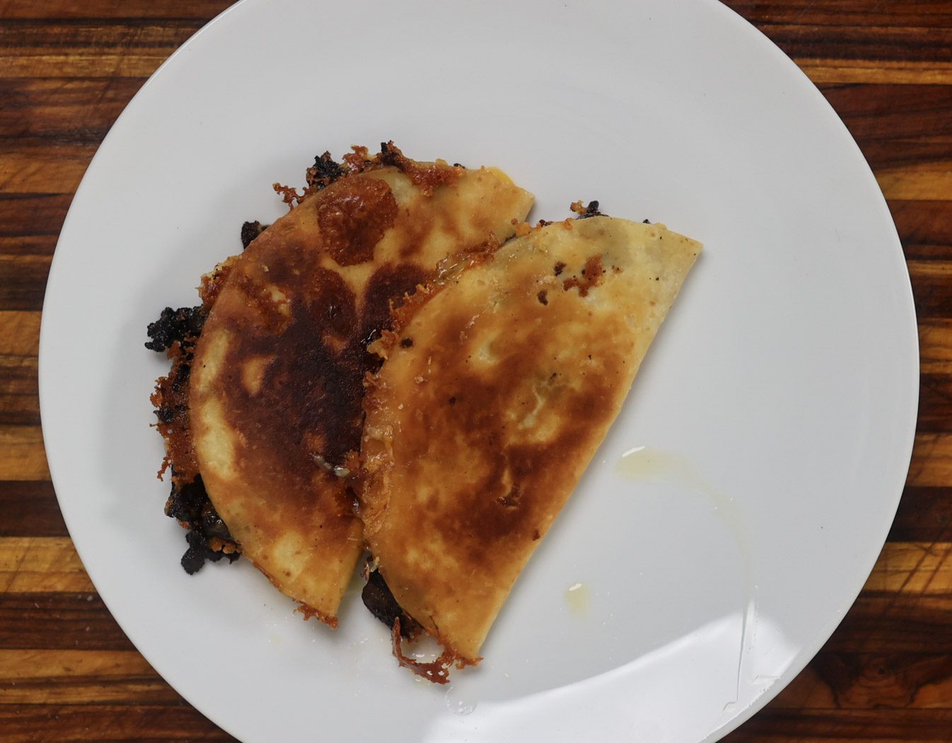 two fried beef tacos on white plate
