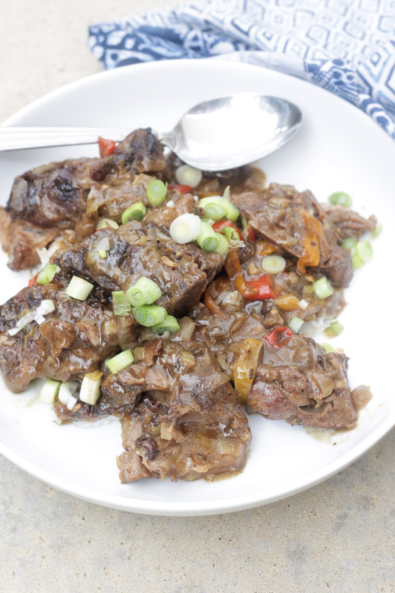 smothered pork neck bones on white plate