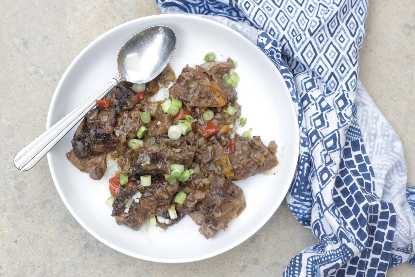 smothered pork neck bones on white plate