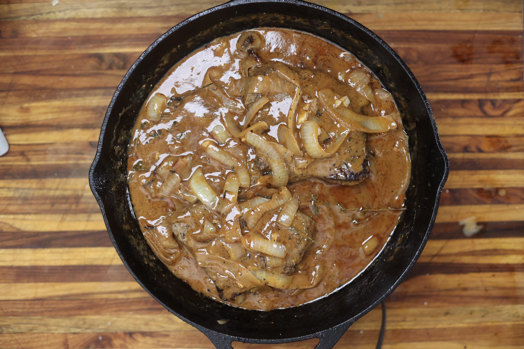 smothered steak and onion gravy in skillet