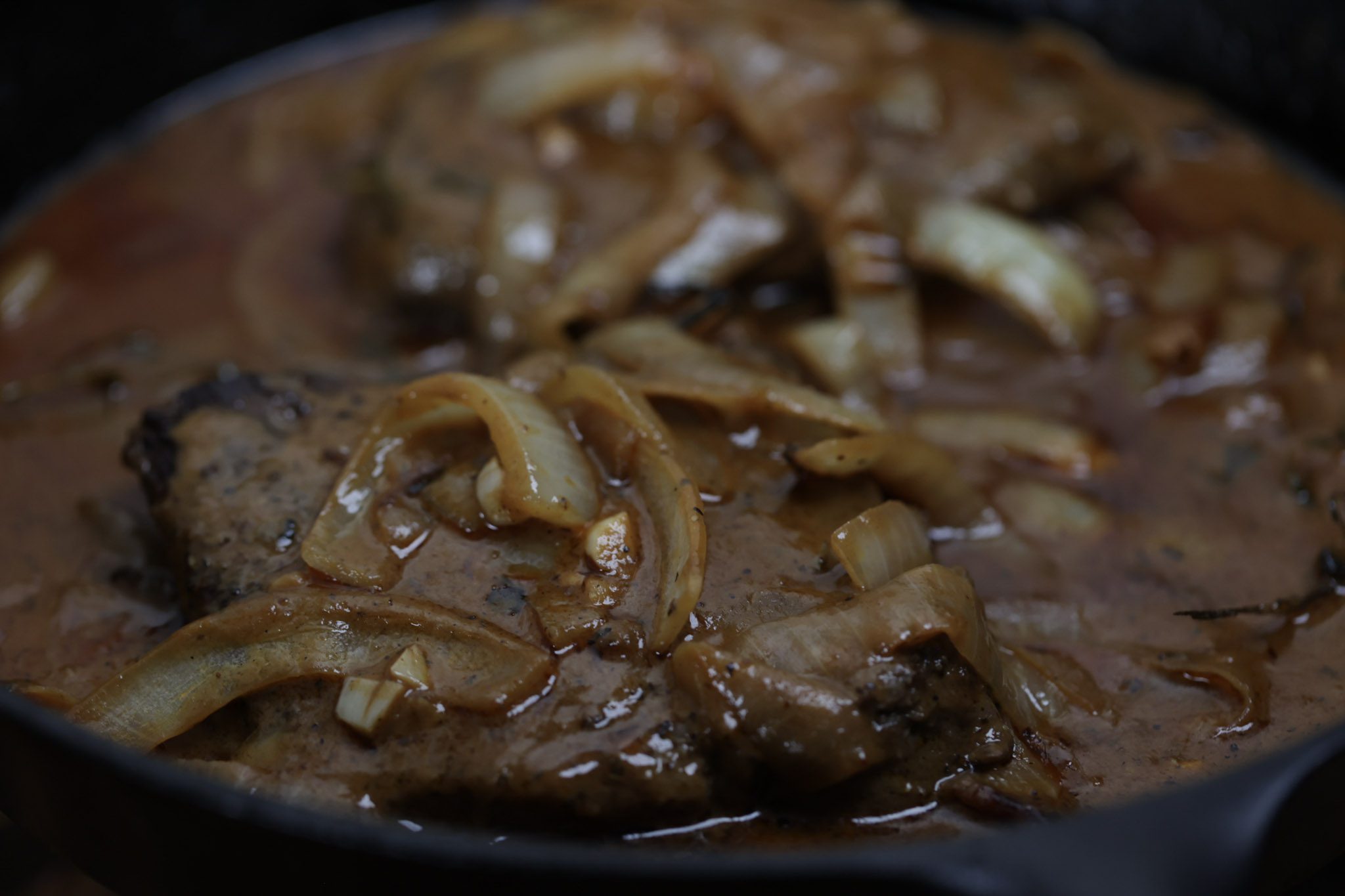 smothered steak and onion gravy in skillet