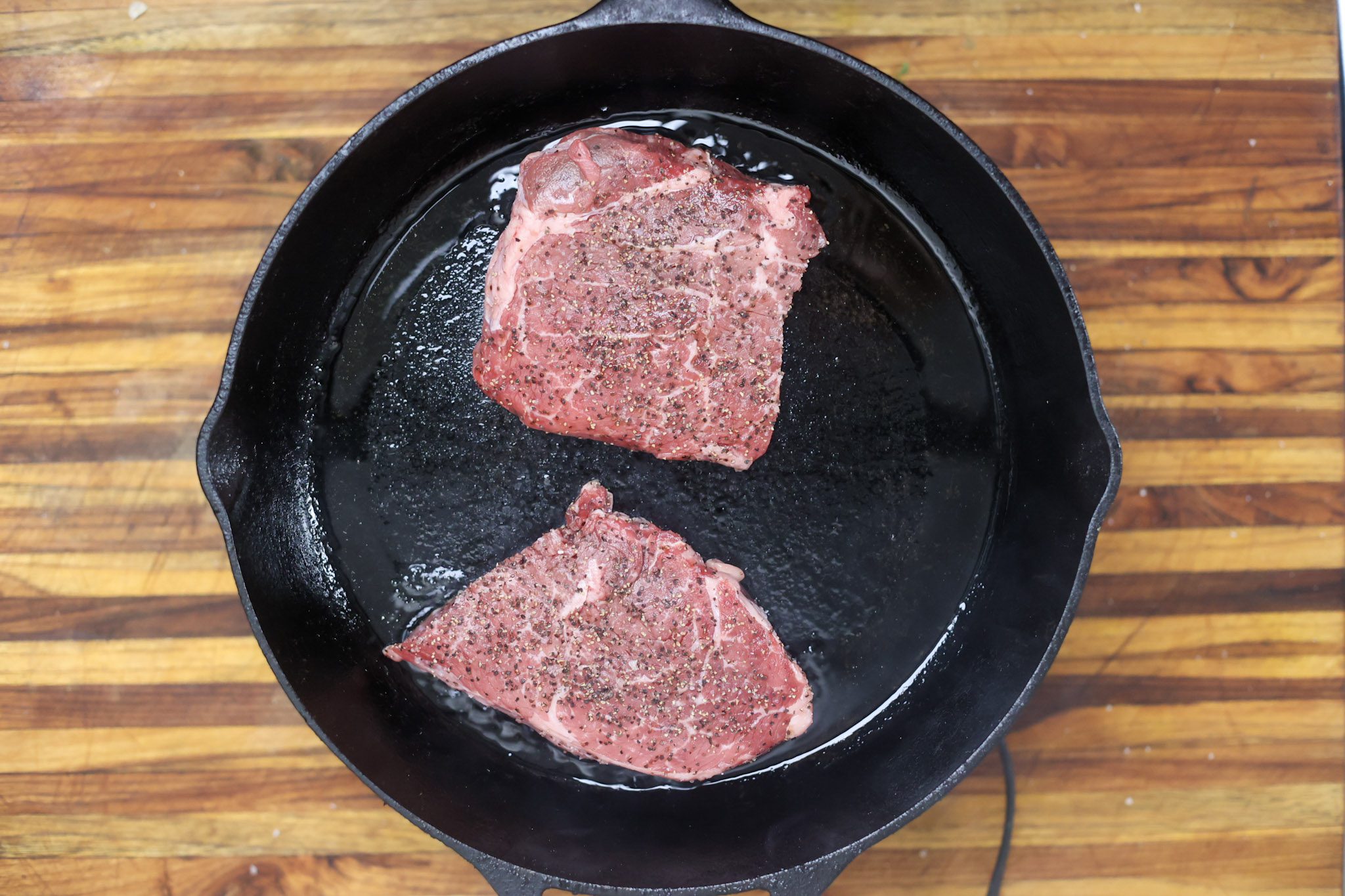 steaks searing in skillet