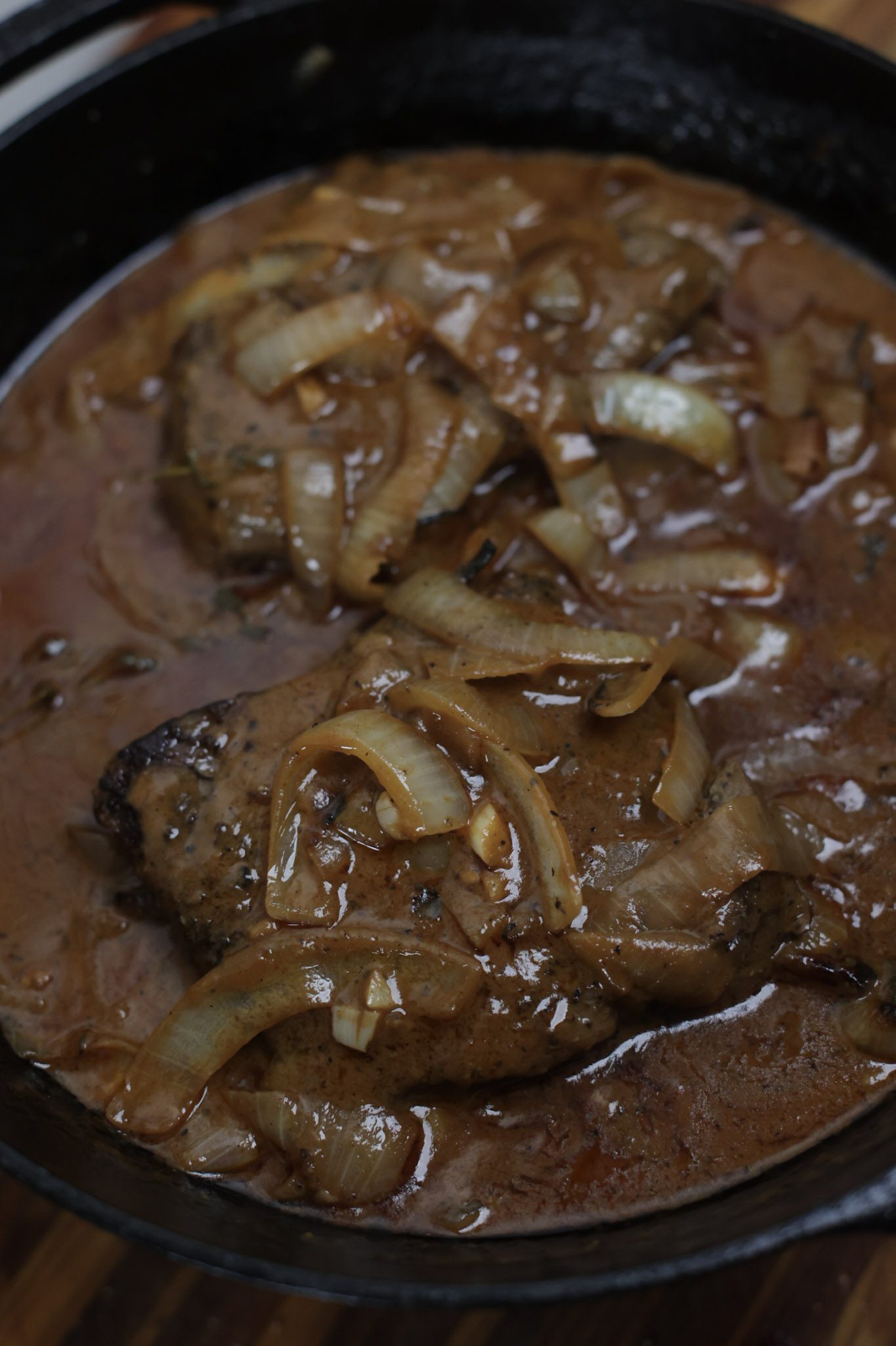 smothered steak and onion gravy in skillet