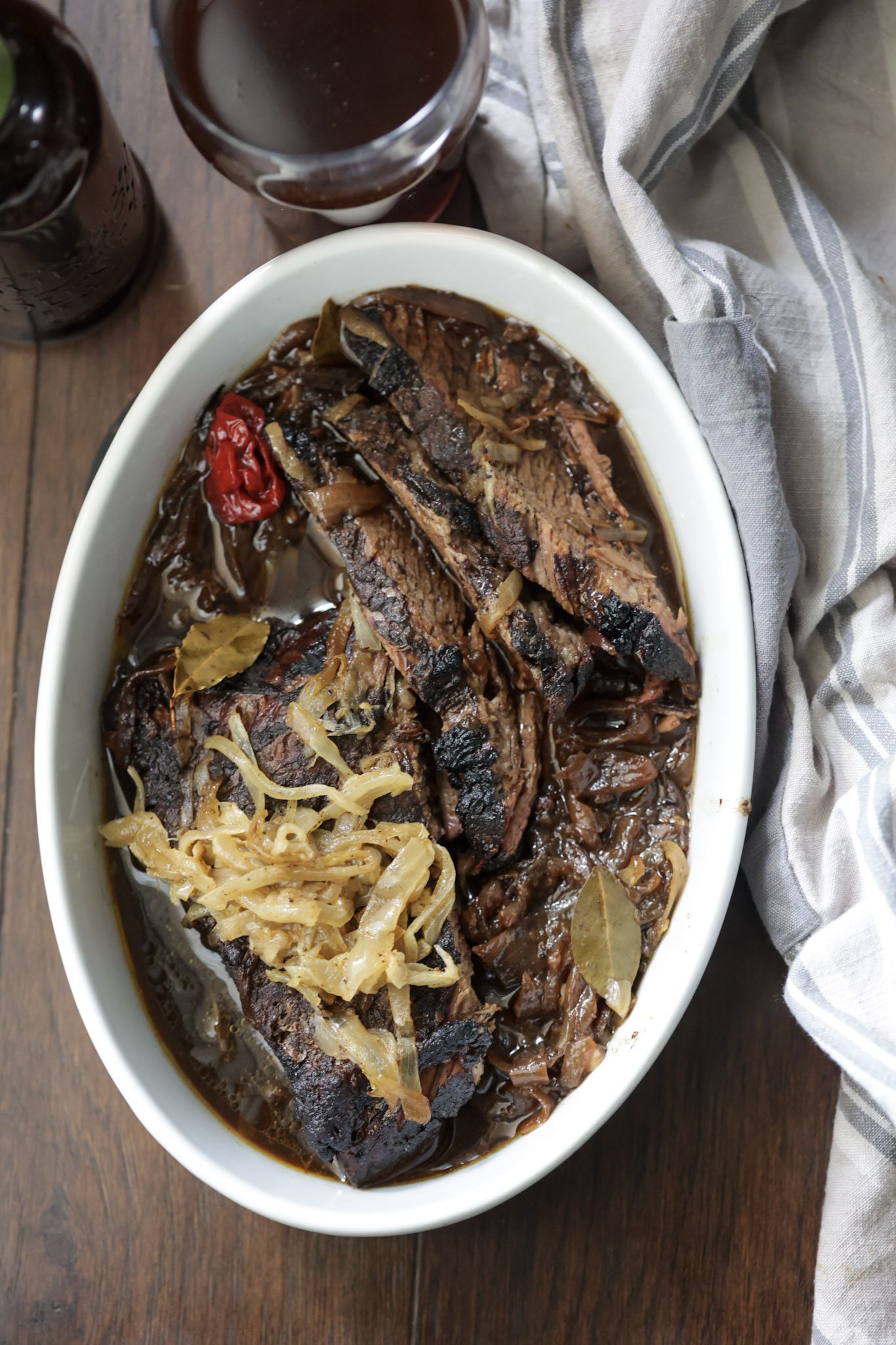 braised brisket and onions in a white bowl
