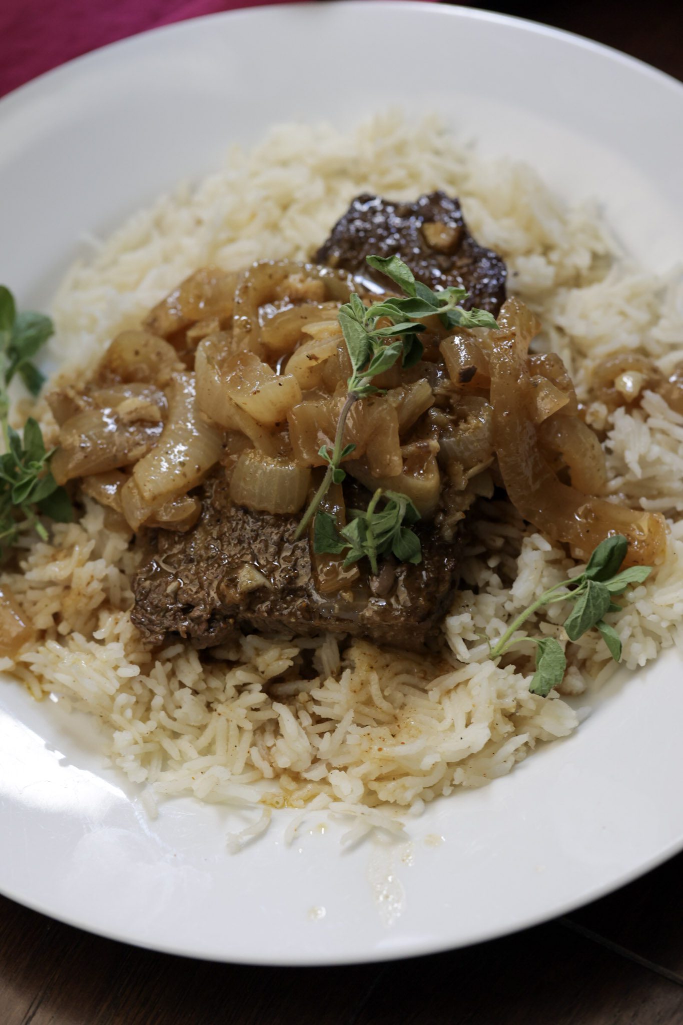 bistec encebollado with rice on plate