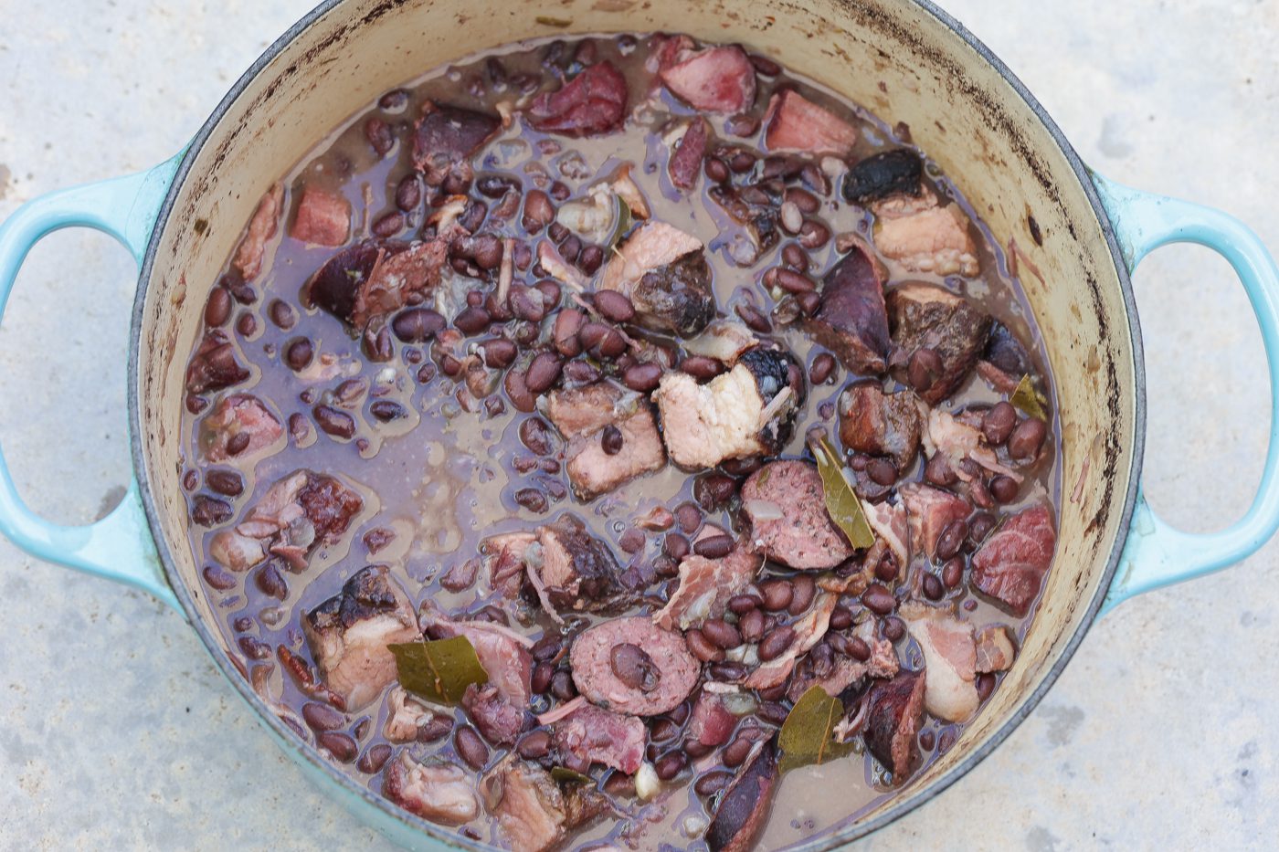 feijoada brazilian black bean and pork stew in a bowl topped with orange slices