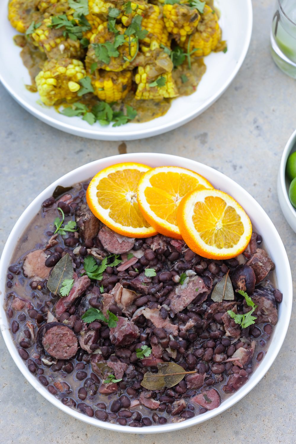 feijoada brazilian black bean and pork stew in a bowl topped with orange slices