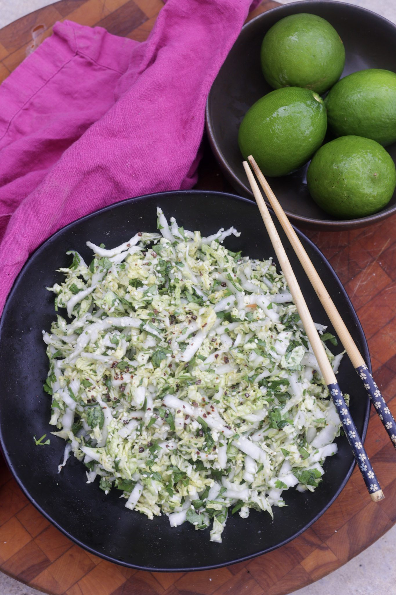 napa cabbage slaw in black bowl
