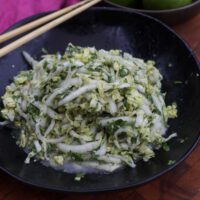 napa cabbage slaw in black bowl