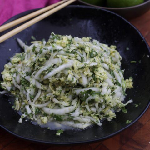 napa cabbage slaw in black bowl