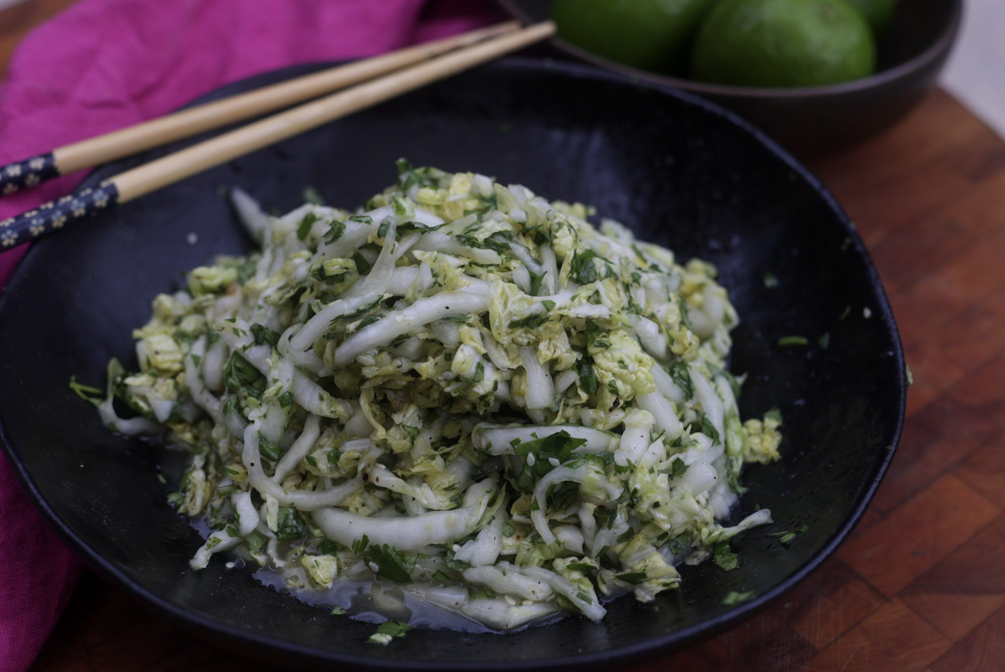 napa cabbage slaw in black bowl