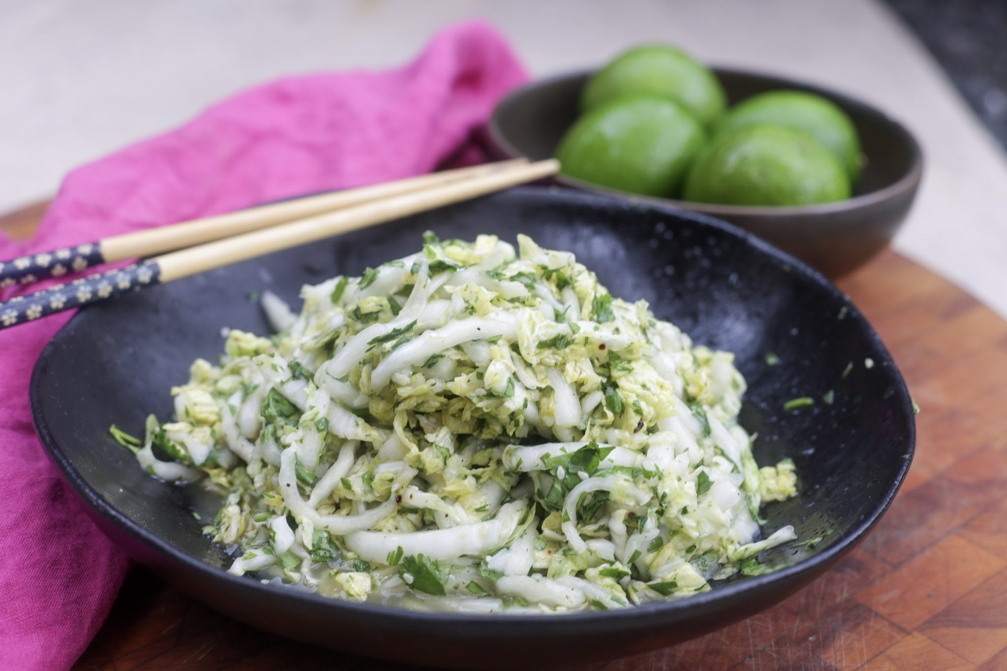 napa cabbage slaw in black bowl