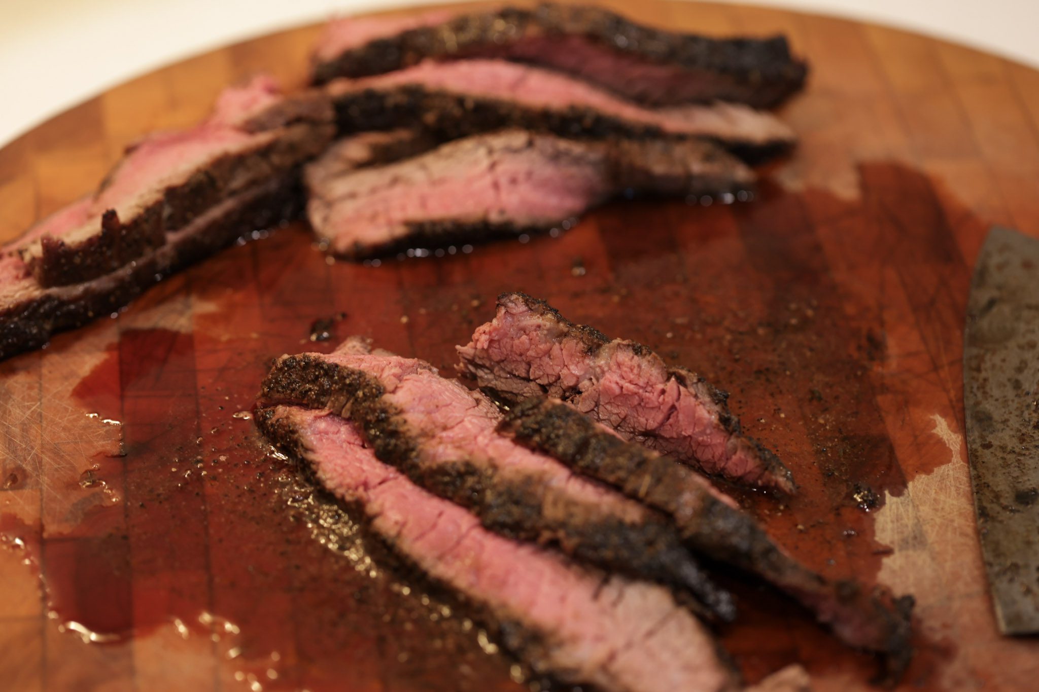 cooked bavette steak slices on cutting board