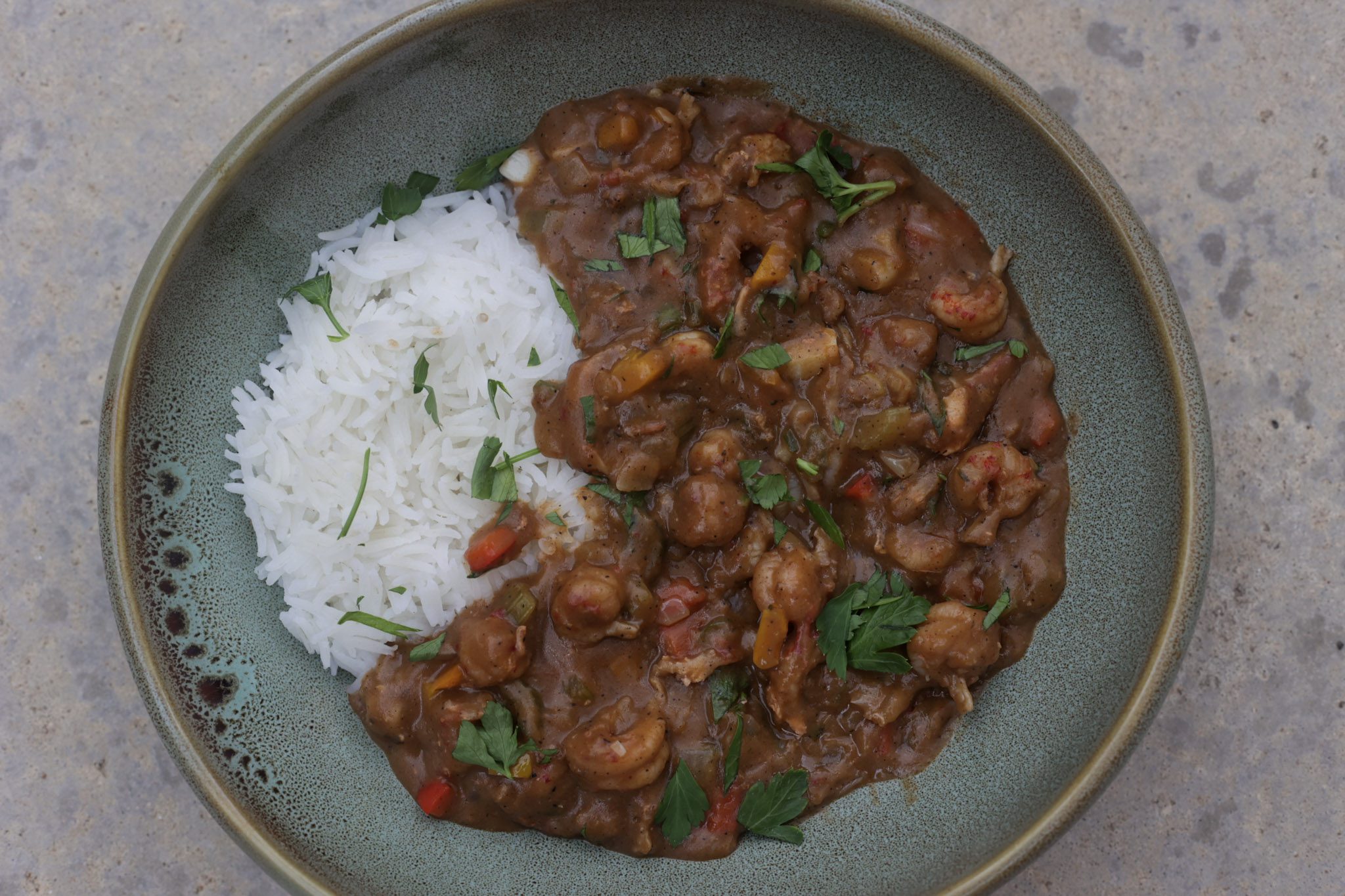 crawfish etouffee and rice in green bowl