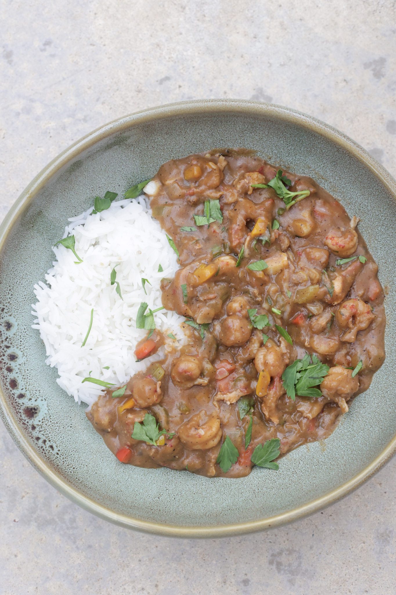 crawfish etouffee and rice in green bowl