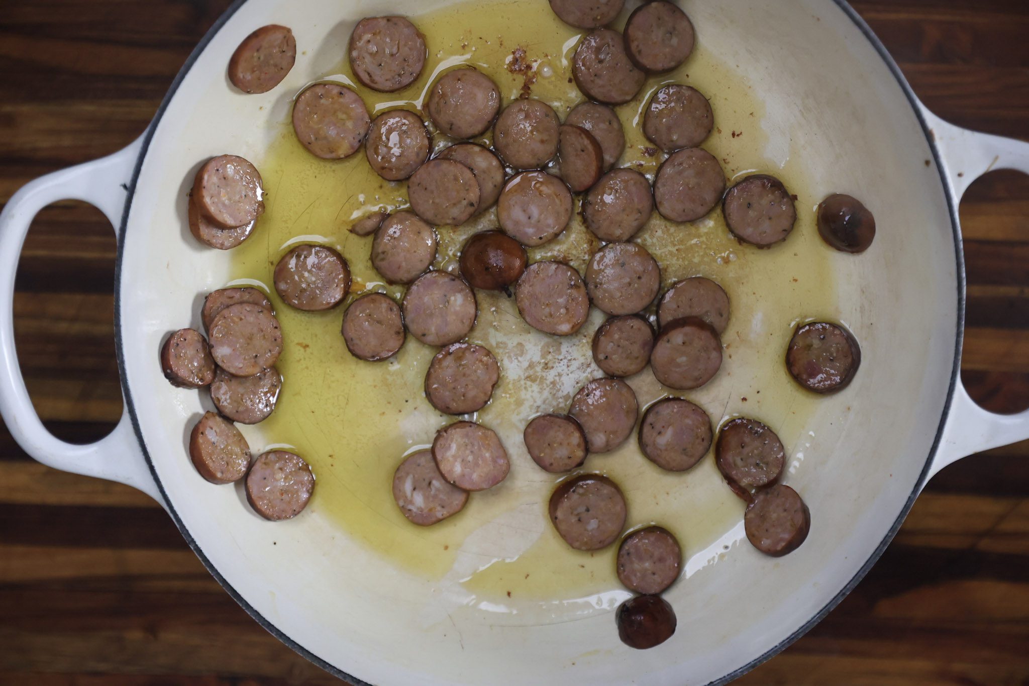 sausage frying in pan