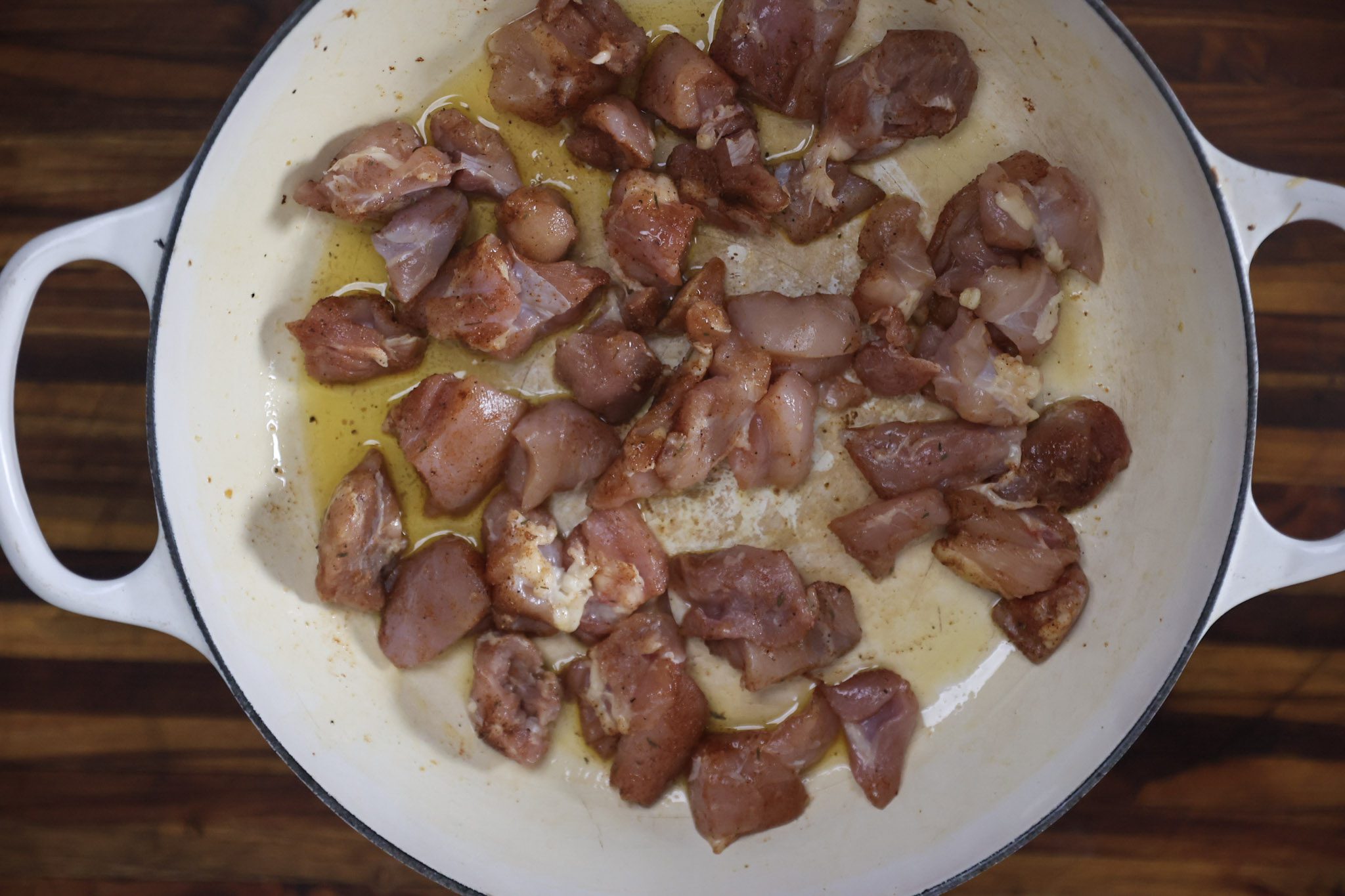 chicken and thighs frying in a pan