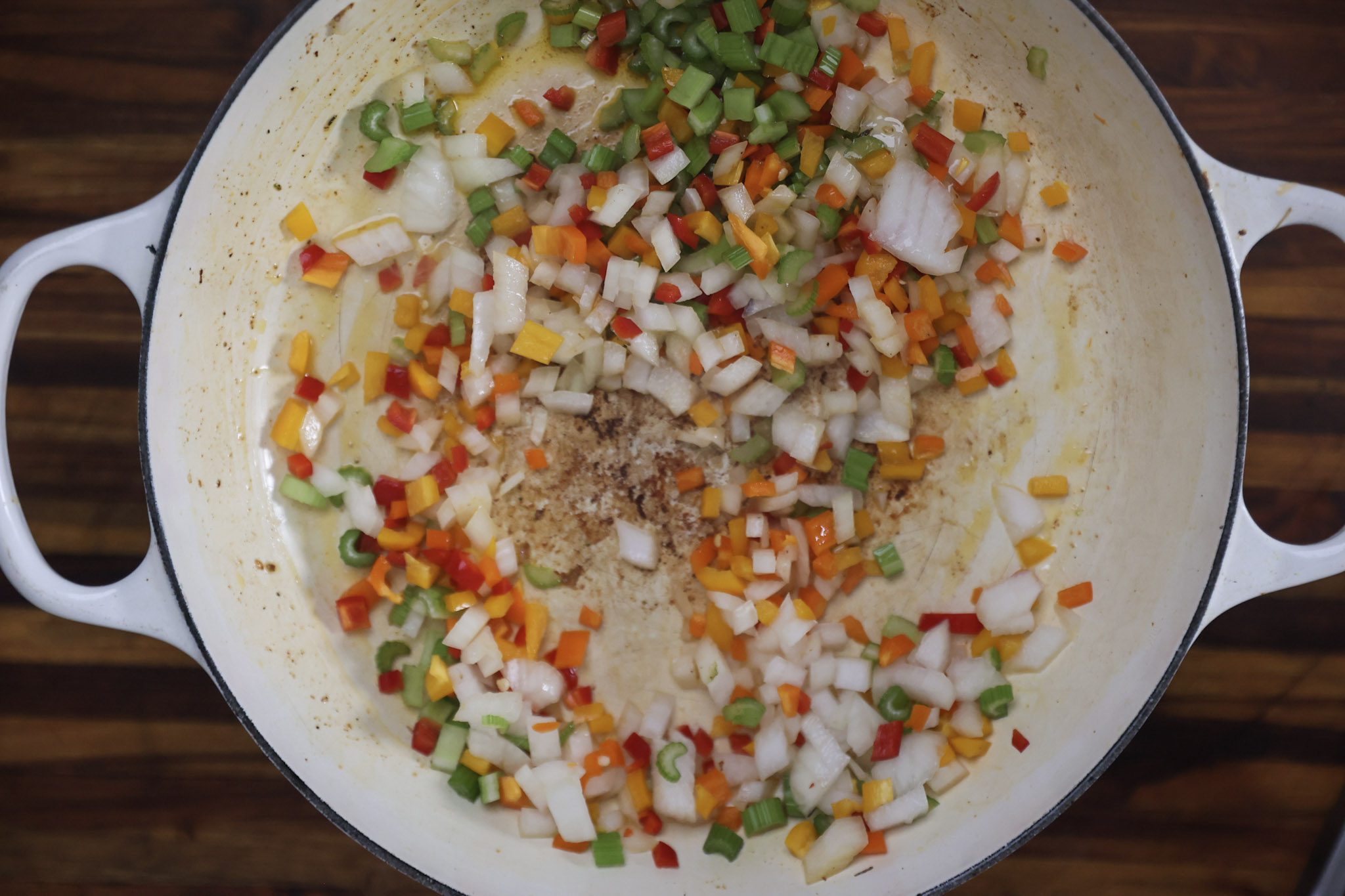 onions, celery, and peppers sauteing in pan