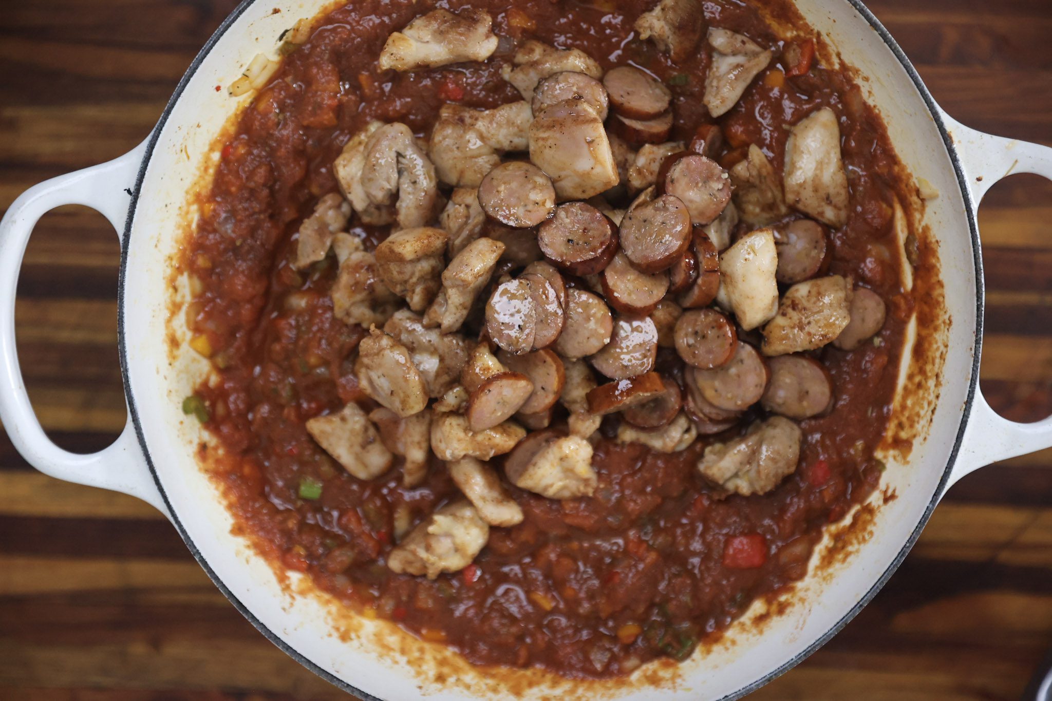 chicken and sausage cooking in red sauce