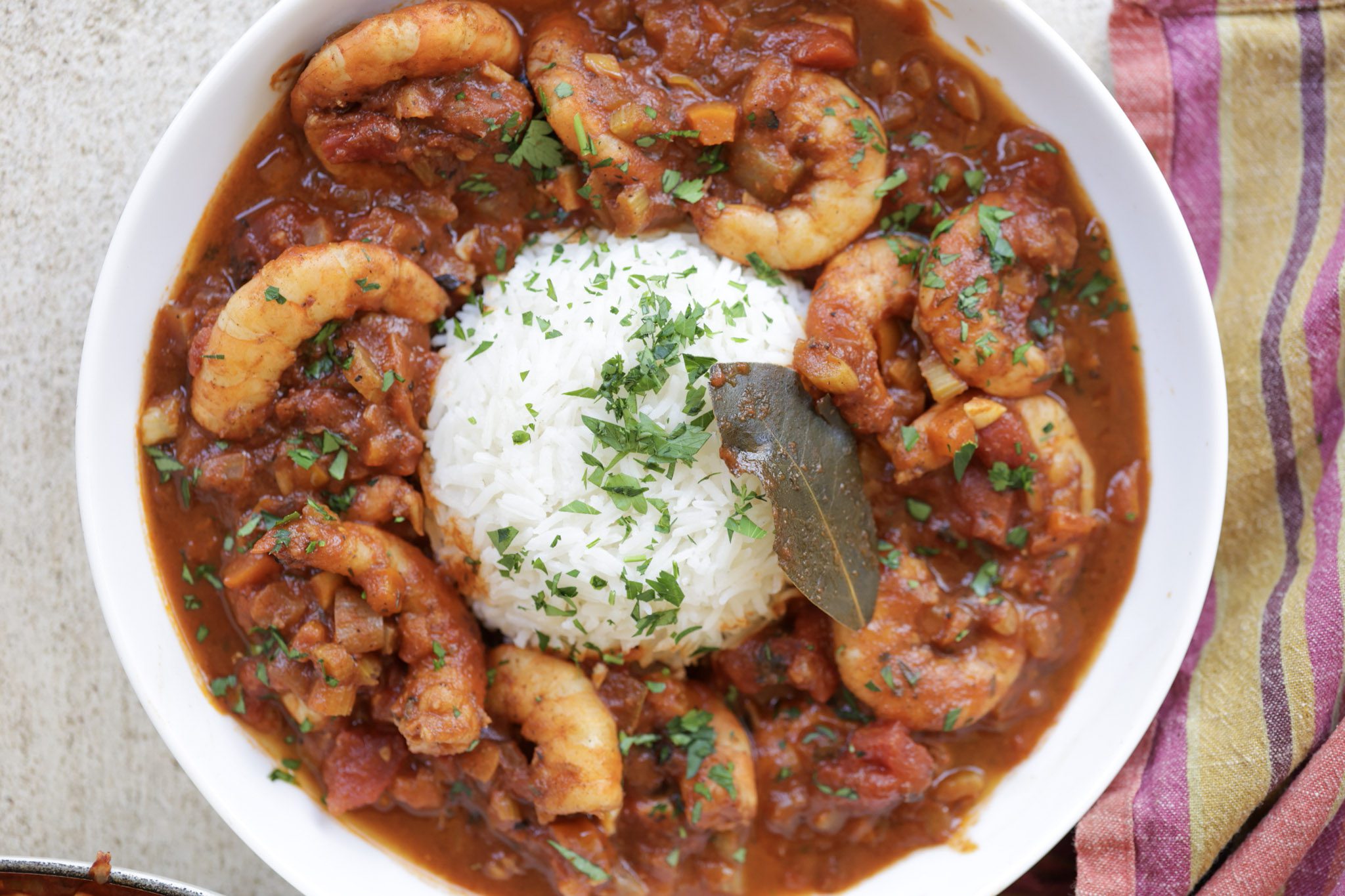 shrimp creole with rice in a white bowl