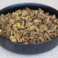 dirty rice in a black bowl