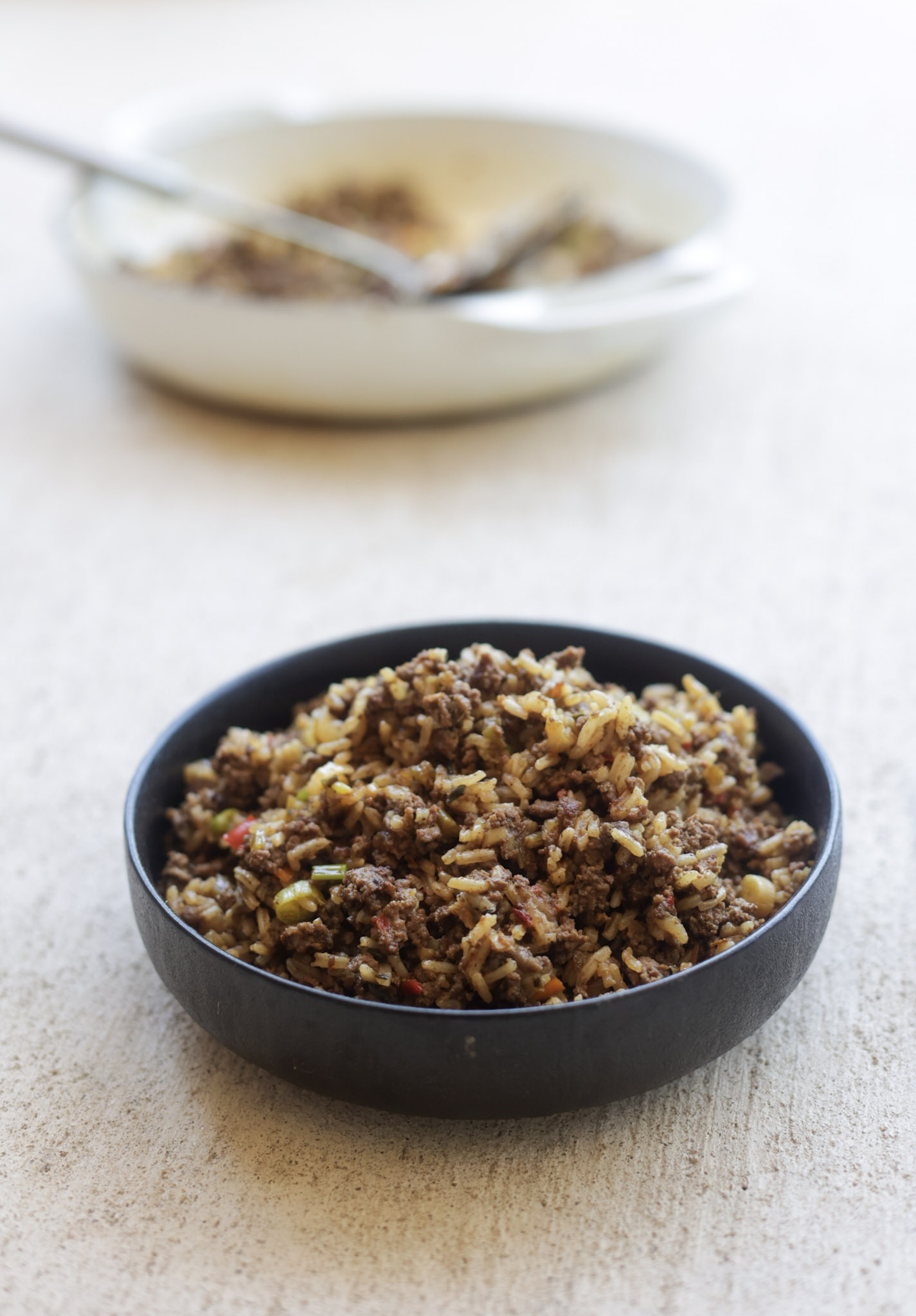 dirty rice in a black bowl