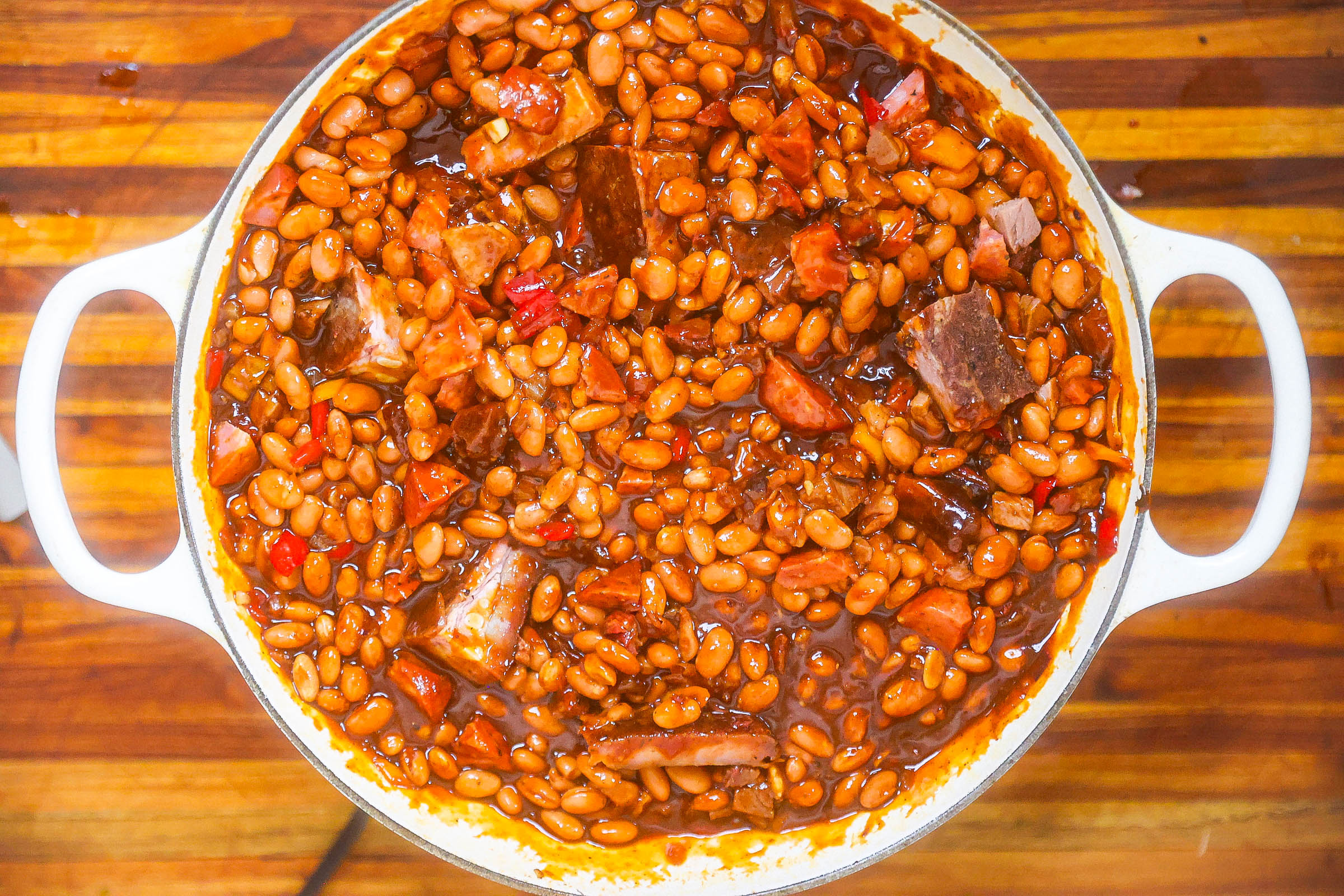 bbq beans cooking in white pan