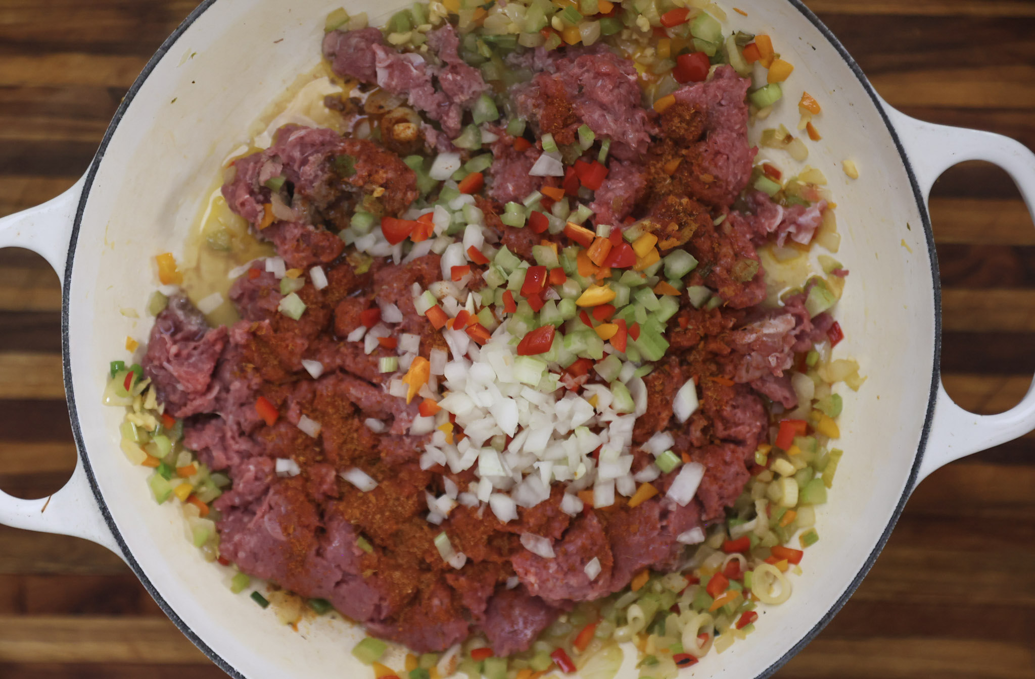 vegetables and ground meat sauteing in pan