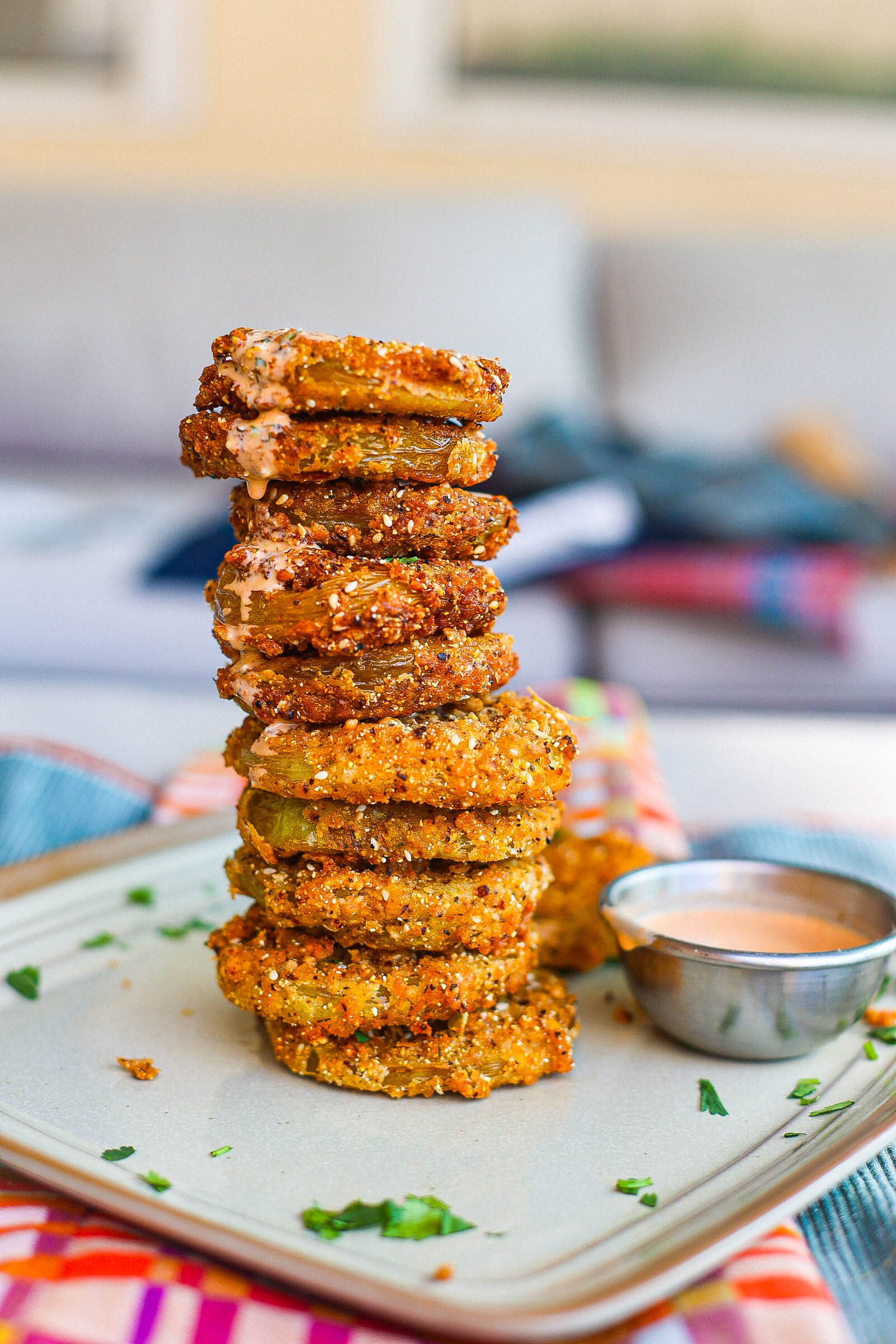 crispy fried green tomatoes stacked on square plate