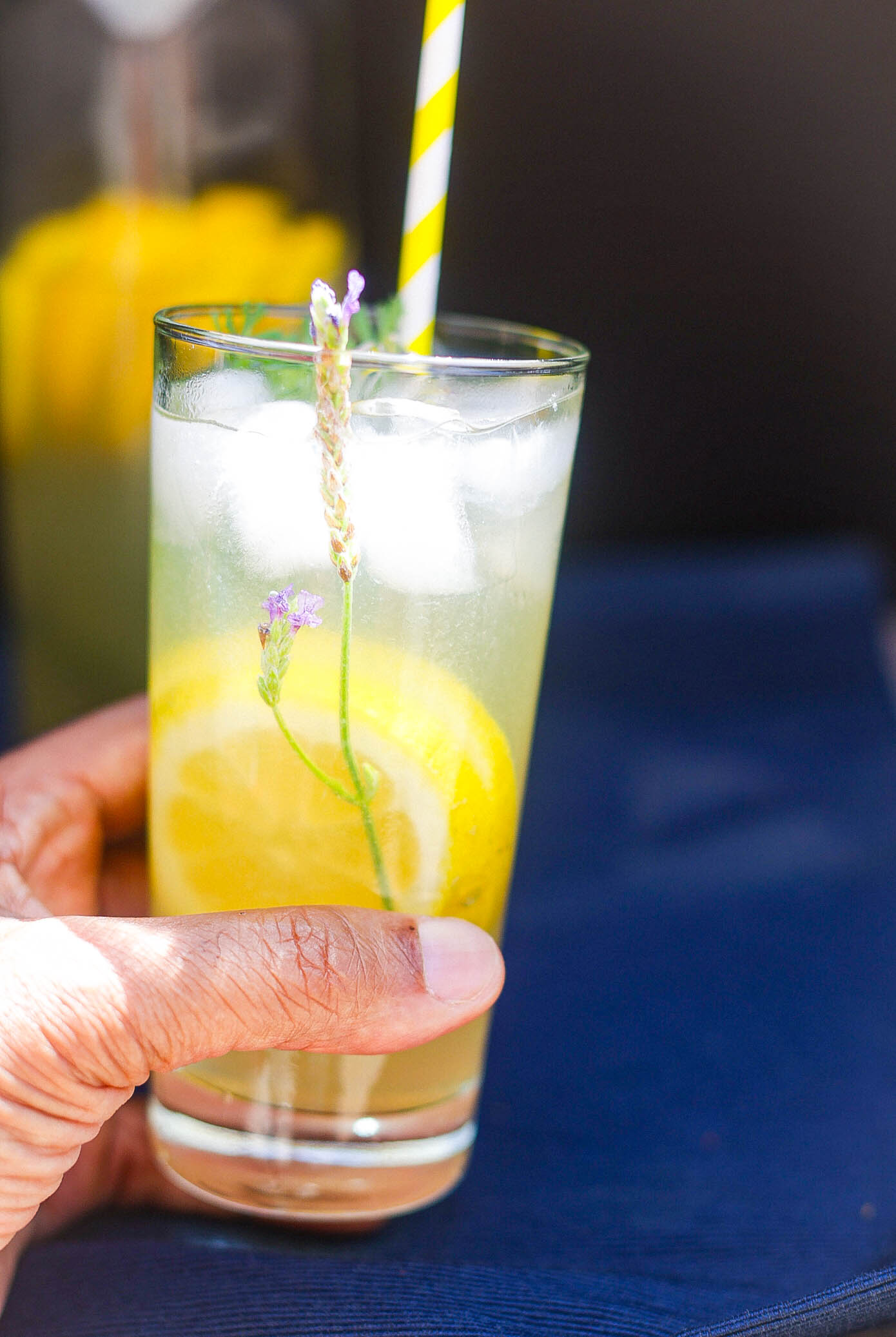 hand holding glass of lavnder lemonade