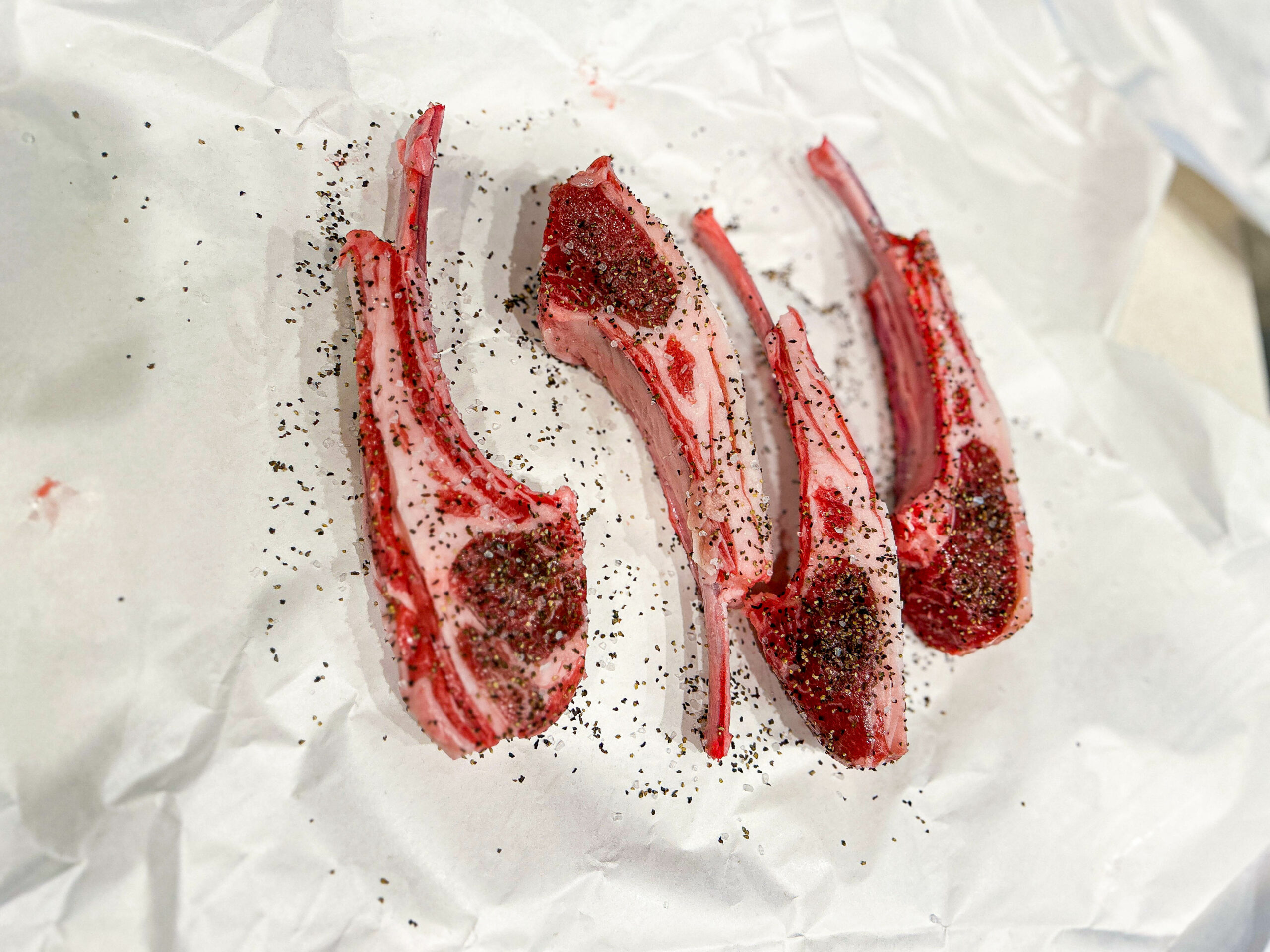 seasoned lamb chops on white paper