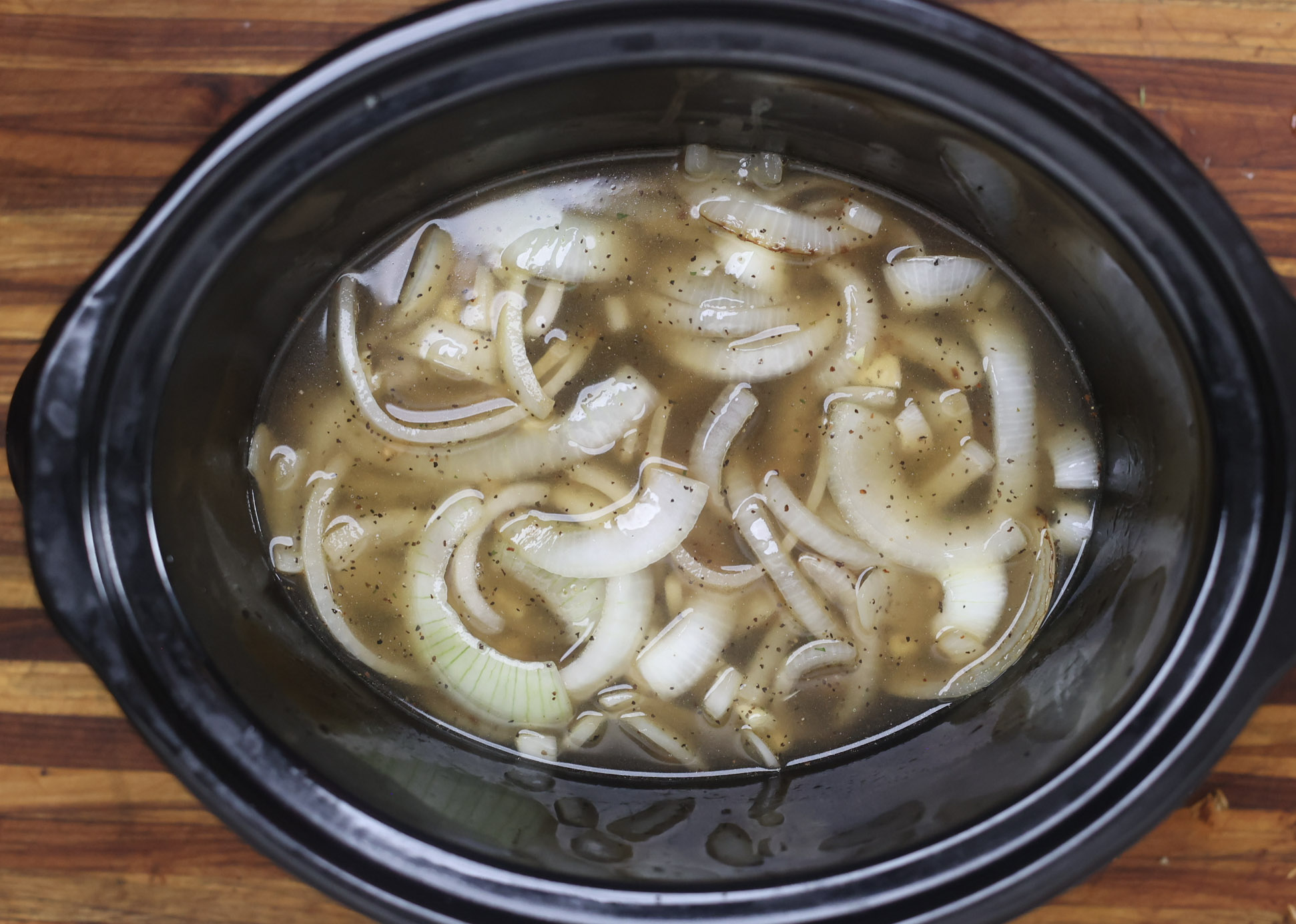 collard greens and onions cooking in slow cooker