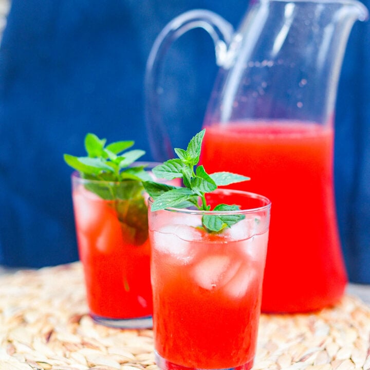 rum punch in two glasses plus a tall pitcher